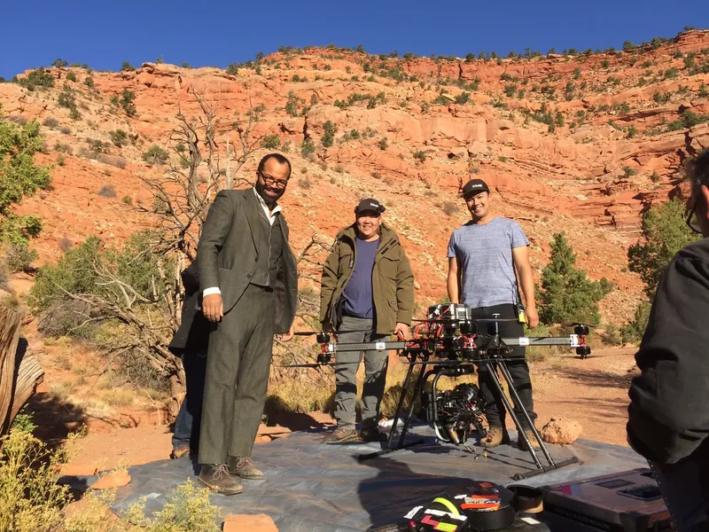 Drone crew with heavy-lift cinema drone in a red rock canyon on location
